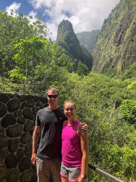 Iao Needle - Man and woman posing for photo in front of the Iao Needle in Maui. 