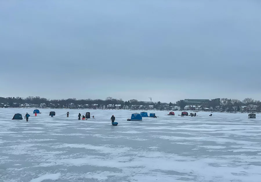 Many individuals and ice shanties fishing on Lake Monona on a dreary day - Winter Outdoor Activities
