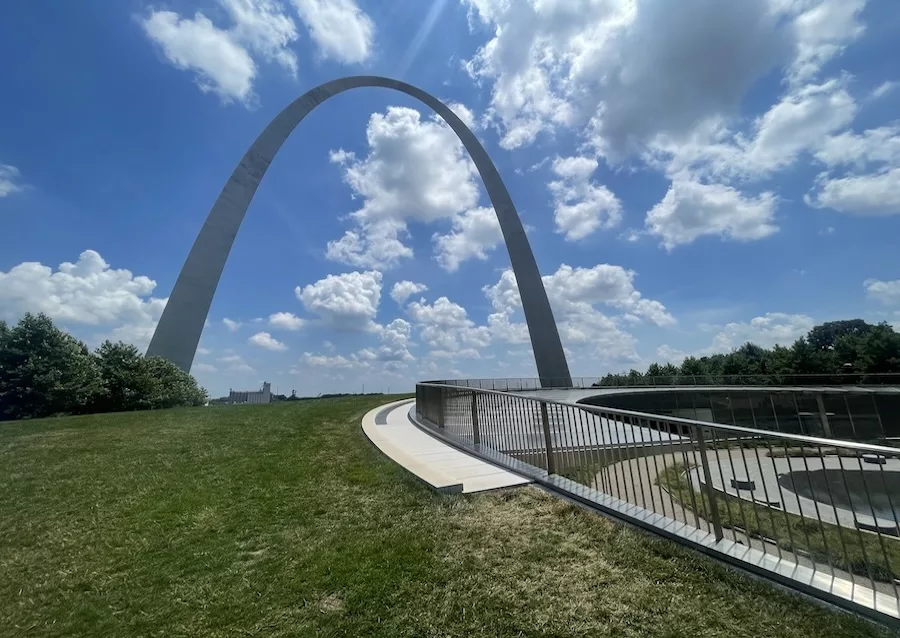 Image of Gateway Arch at Gateway Arch National Park in St. Louis, Missouri. Bright blue and cloudy sky.