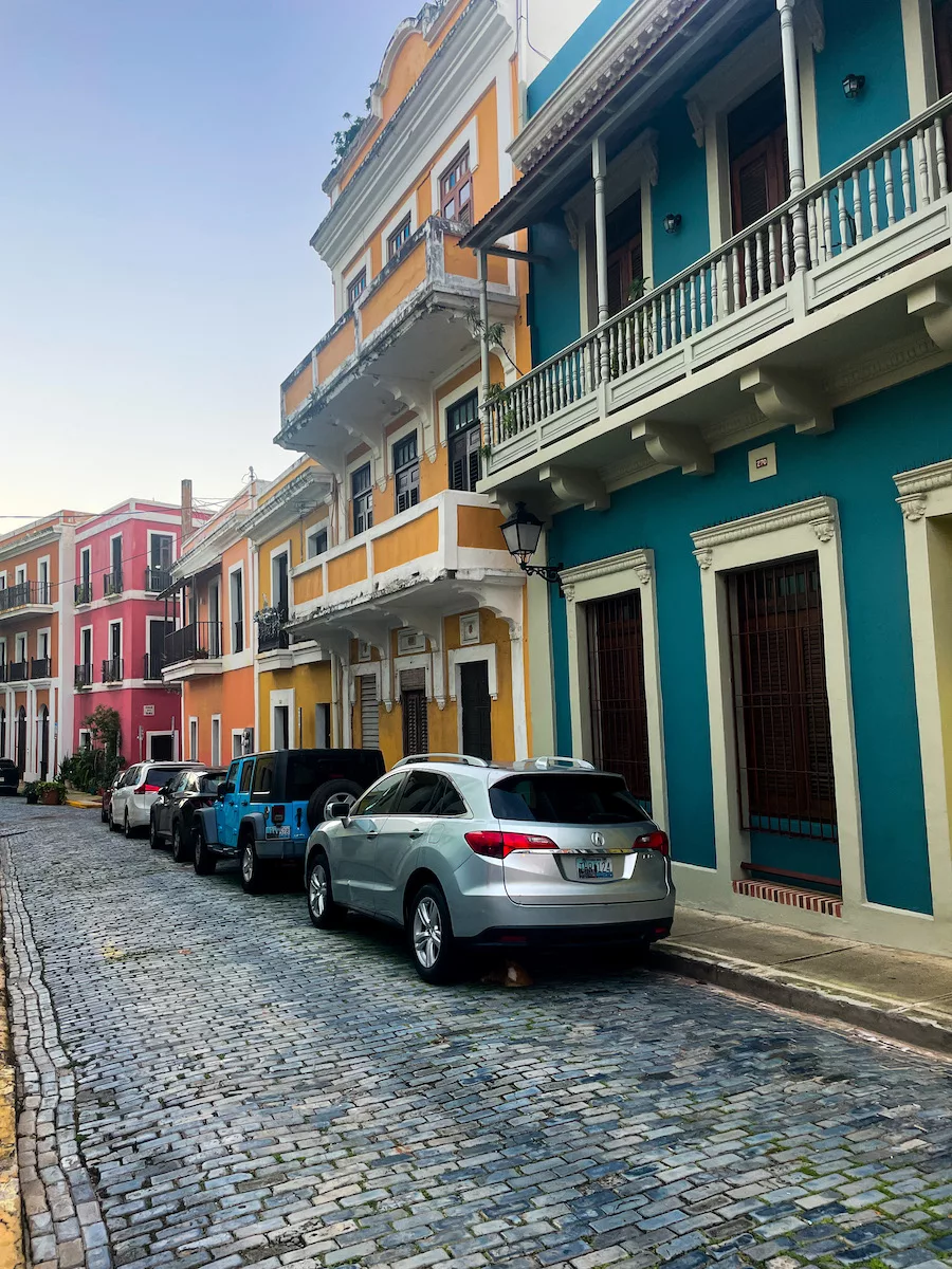 Old San Juan, Puerto Rico - Street View with cars parked on the street and colorful buildings 
