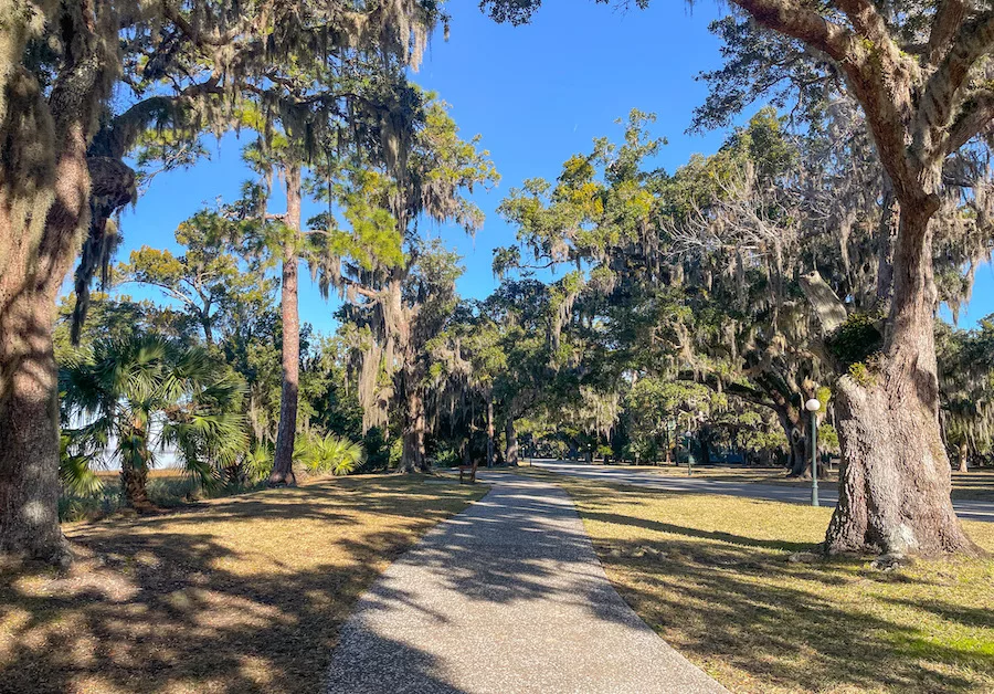 Visiting Jekyll Island - paved walking path lined with oak trees and spanish moss hanging from branches