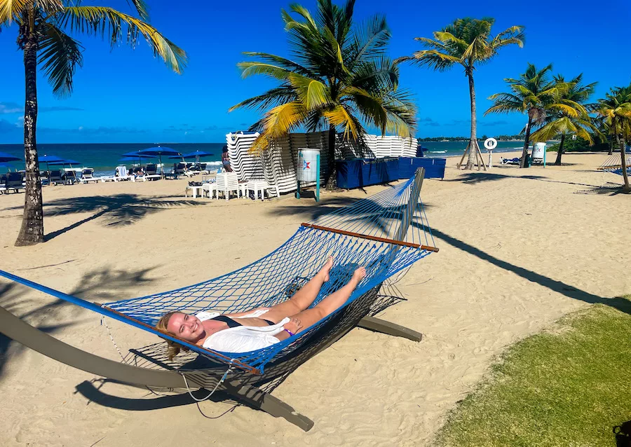 Woman in hammock on beach at Courtyard Isla Verde Beach Resort