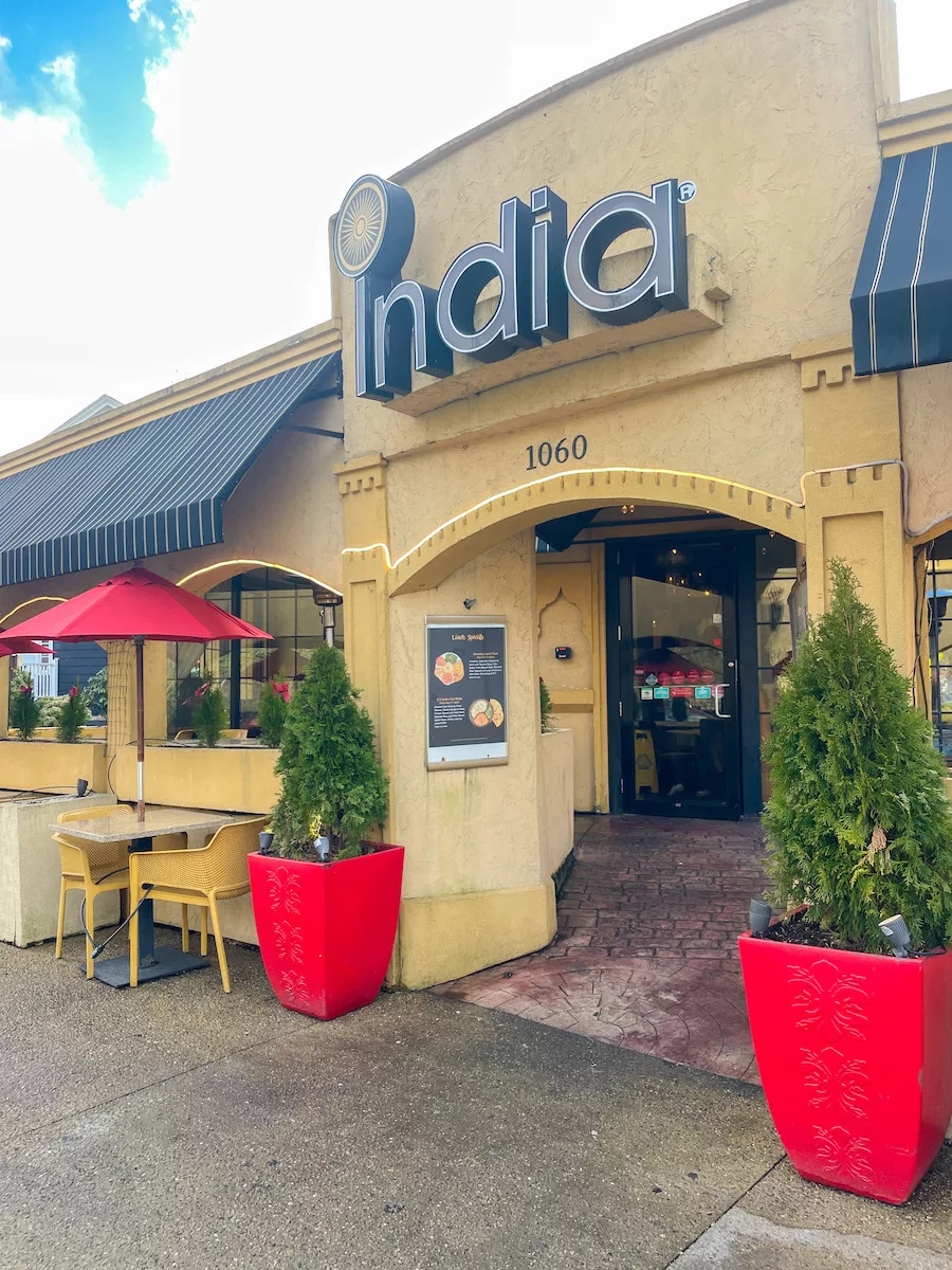 India Restaurant entrance with outdoor seating. 