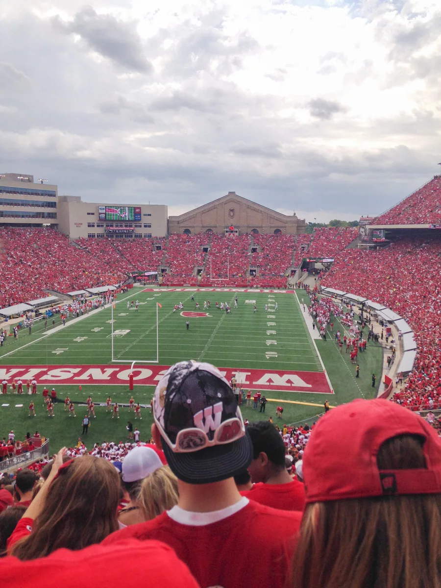 Football stadium filled with fans wearing red. 