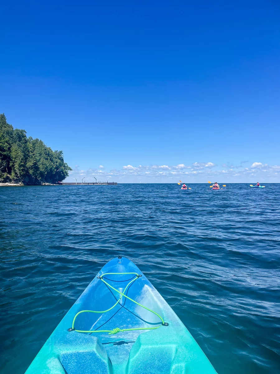 Blue water of Lake Michigan with tip of kayak from view of kayaker 