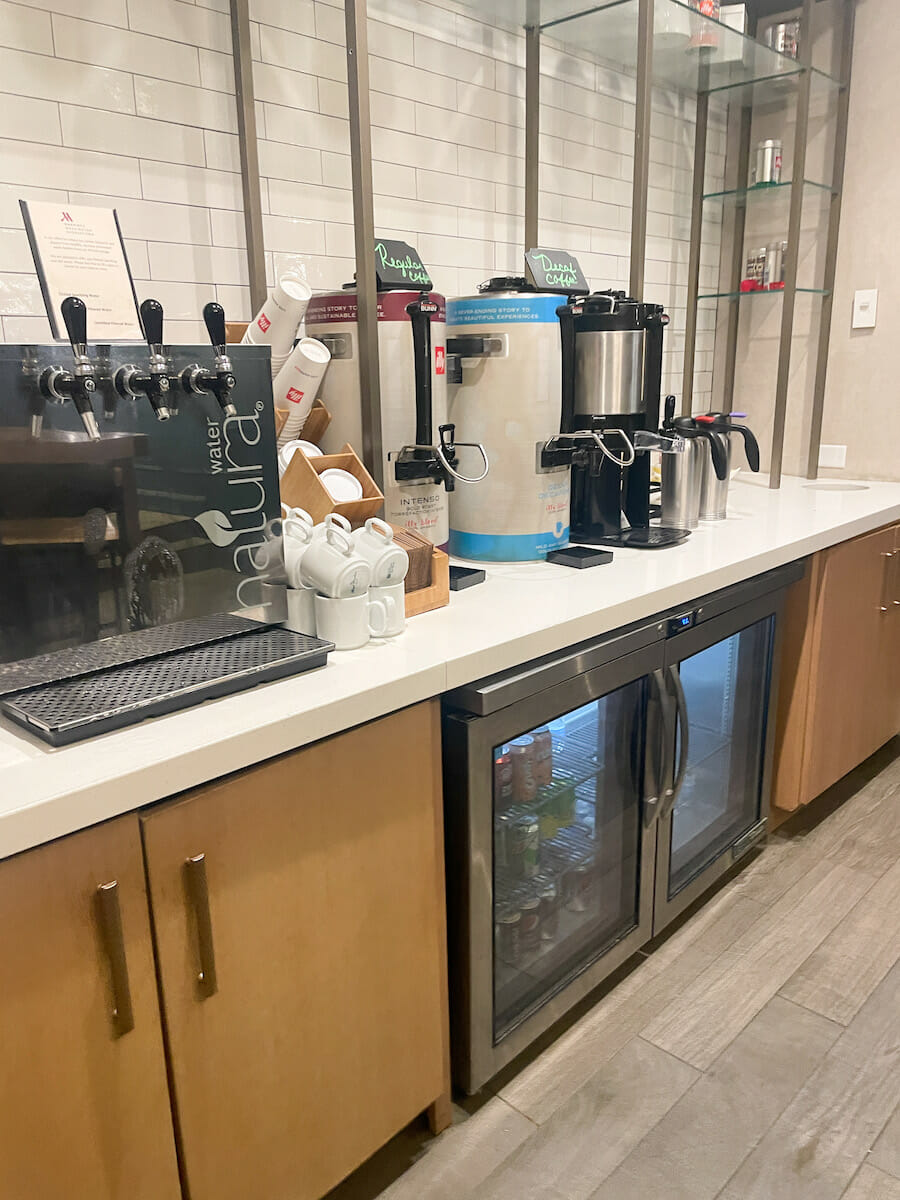 View of a coffee station with multiple coffee options and soft drinks