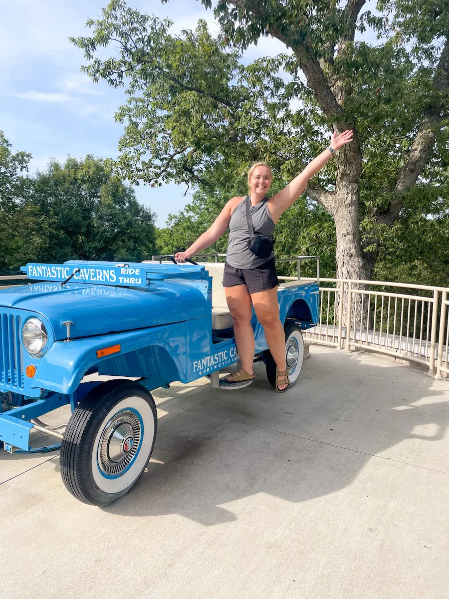 Caves in Missouri - Lady posing on a staged Blue Jeep at Fantastic Caverns in Springfield, MO