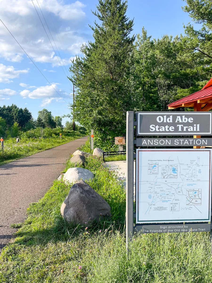 Paved bike trail with Old Abe State Trail Sign in Eau Claire, WI - Outdoor Activities in Eau Claire