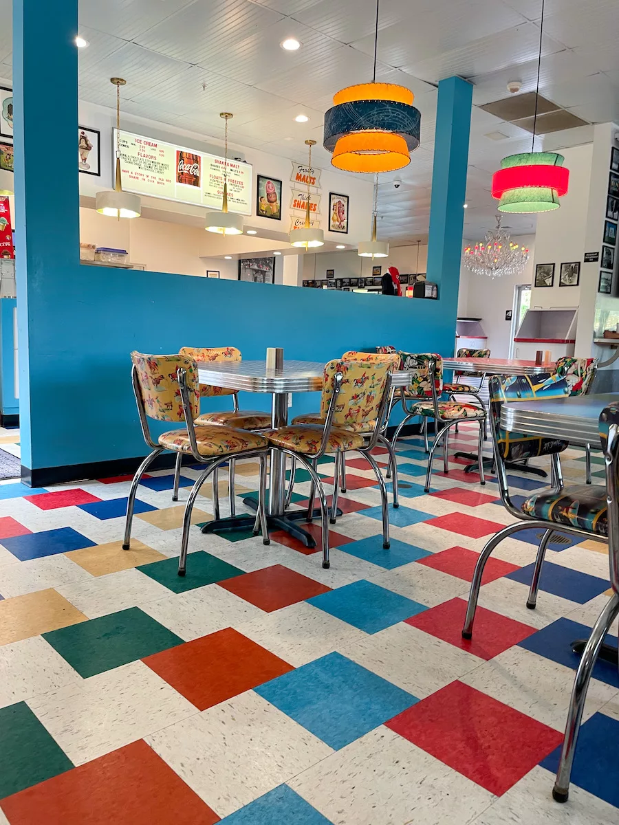 Restaurants in Springfield - Retro diner look at Red's Giant Hamburg. Checkered floor with colorful walls and lights. 