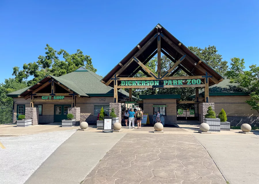 Entrance to the Dickerson Park Zoo in Springfield, MO where people are waiting in line to enter the zoo. 