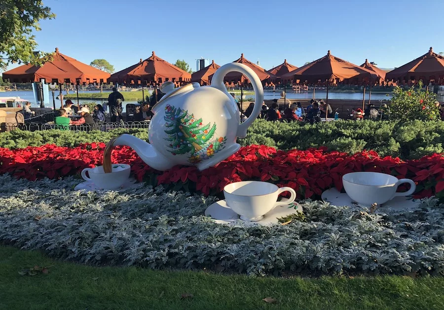 Holiday-Themed teapot pouring tea into a cup in Epcot at Walt Disney World. 