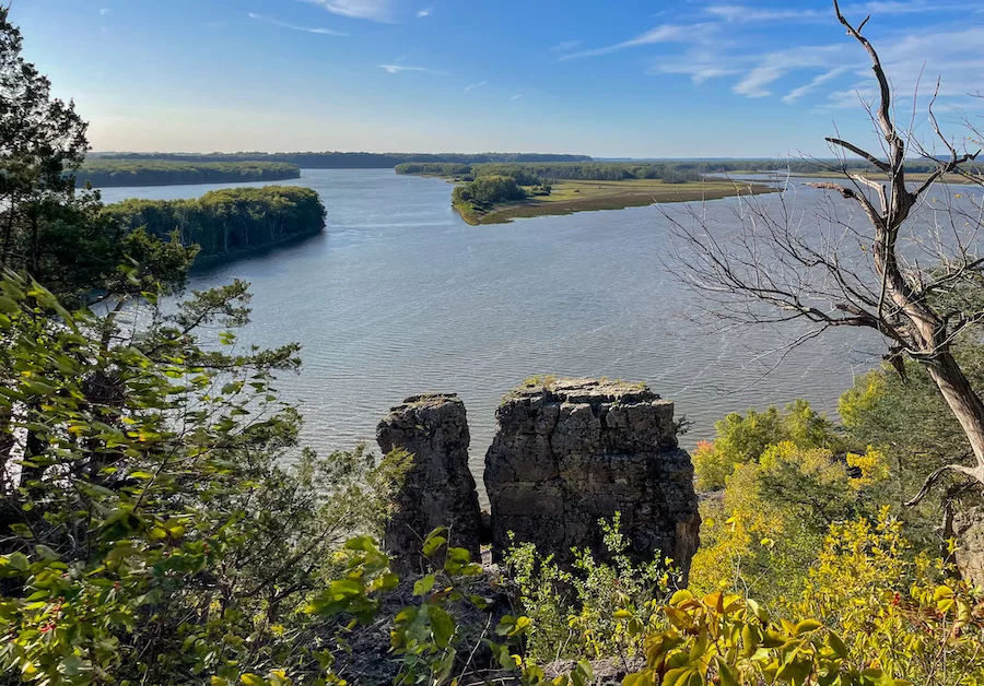 Office to Outdoors Cover - View of Mississippi River and cliff formations surrounded by green foliage from Sentinel Trail in Mississippi Palisades State Park