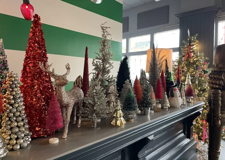 Mini Christmas Trees decorating a mantle - Holiday Events in Downtown Davenport