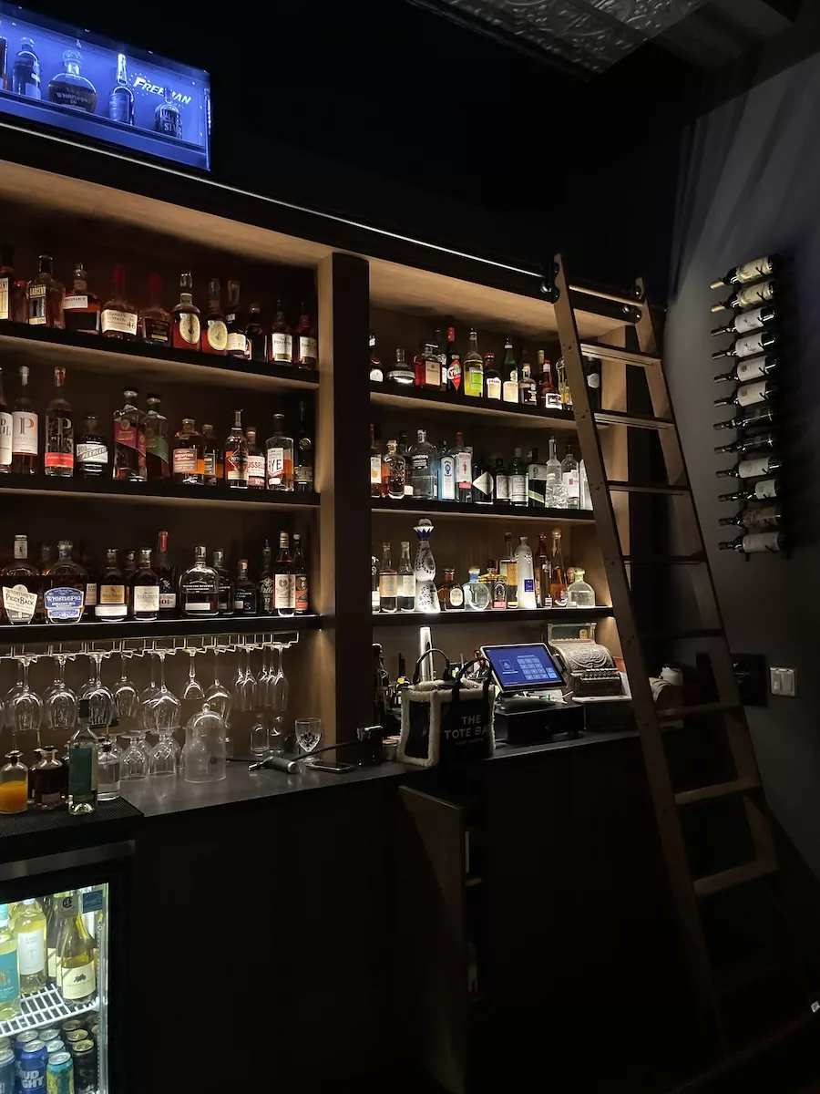 Image of dimly lit bar full of bottles at Garrison Speakeasy