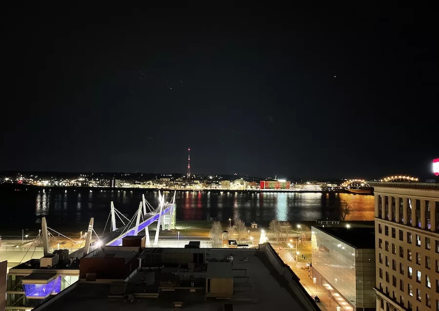 View of the Davenport Riverfront at night from Sky Bar - Food and Drink in Downtown Davenport