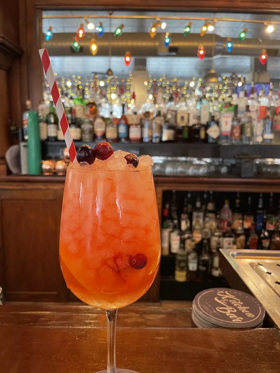 Image of holiday sangria drink in front of bar at Me and Billys in downtown Davenport, Iowa
