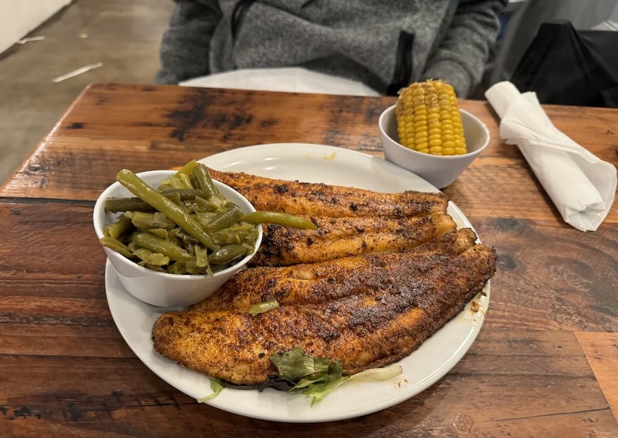 Image of plated grouper with a side of beans and corn-on-the-cob in Jacksonville, Florida
