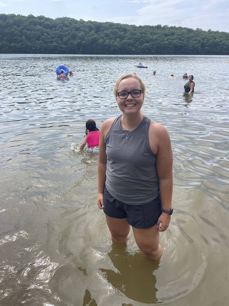 Young woman dipping her feet in the beach at Lake of the Ozarks State Park in Missouri