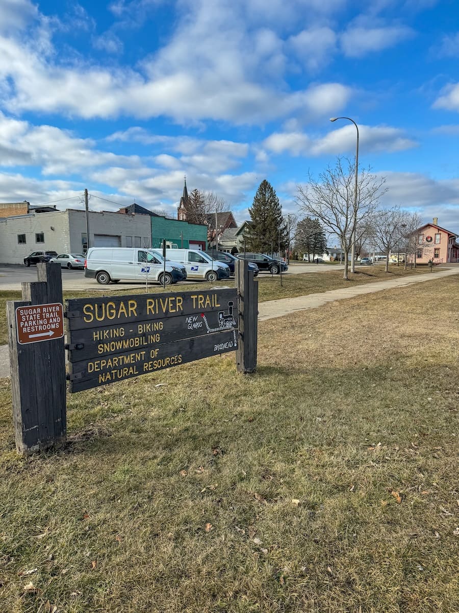 Image of a wooden sign introducing the Sugar River State Trail in New Glarus, Wisconsin