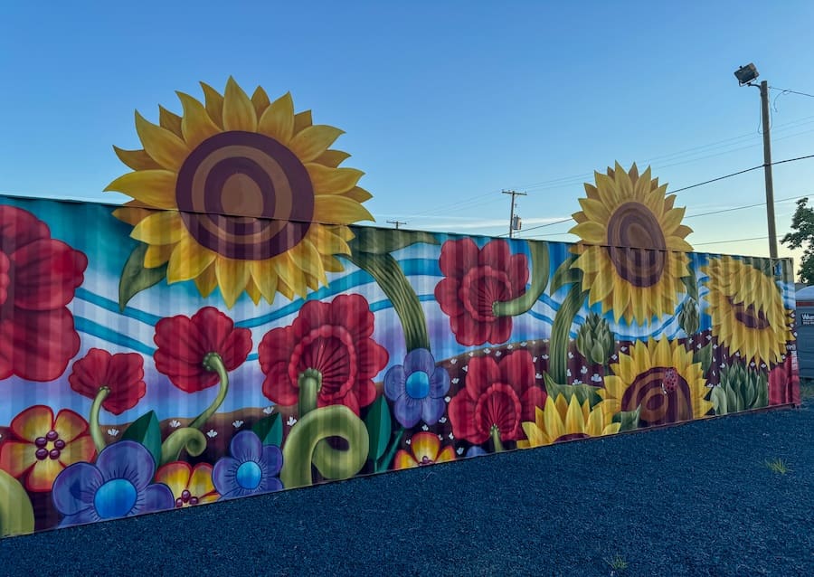 Image of beautifully and vibrantly painted flowers and giant sunflowers. 