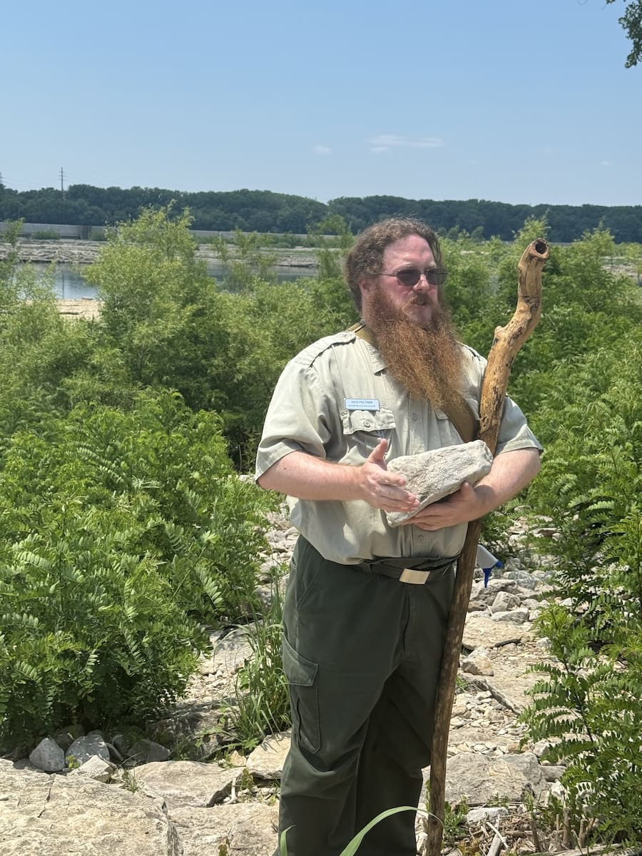 Image of state park ranger holding a fossil and talking about it at Falls of the Ohio State Park