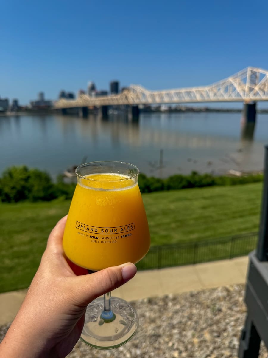 Image of Mimosa and bridge and Ohio River background at Upland Brewing in Jeffersonville, IN