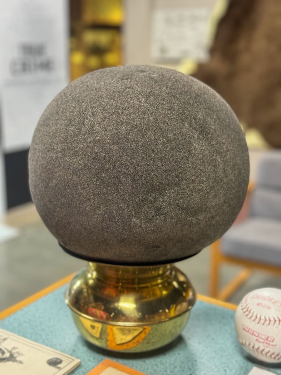 Image of a giant hairball on top of a pedestal in a museum in Kansas. 