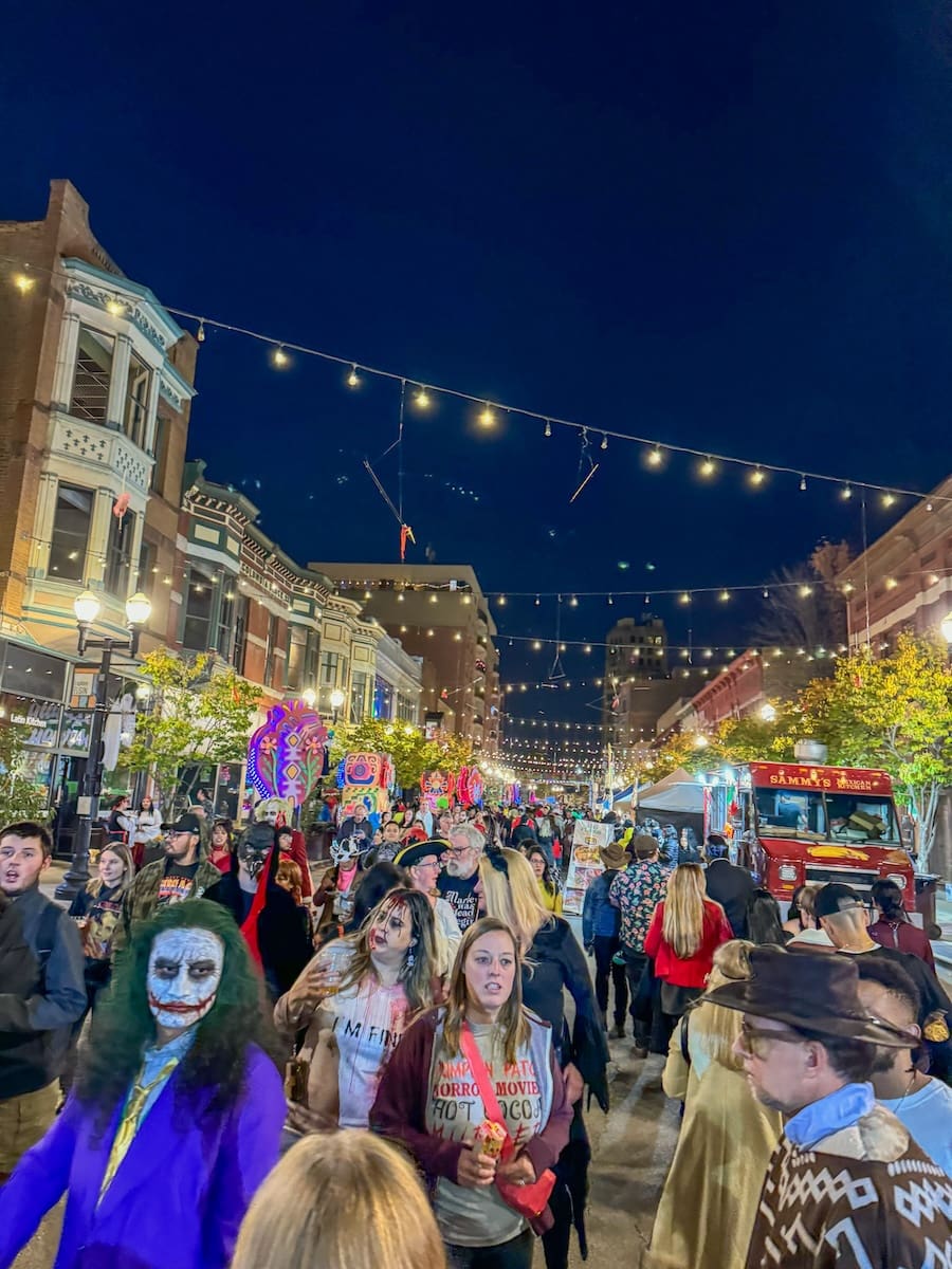 Image of a large crowd of people in Downtown Elgin dressed up for a halloween event. 