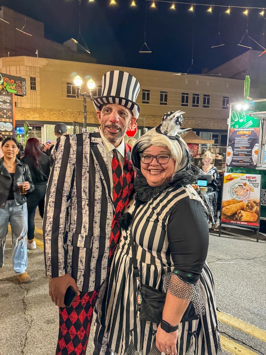 Image of husband and wife dressed up at Nightmare on Chicago Street