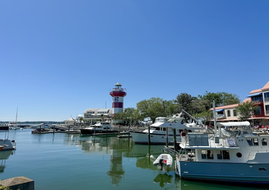 Image of Harbour Town and the Harbour Town Lighthouse surrounded by blue sky and water - Guide to Hilton Head Island