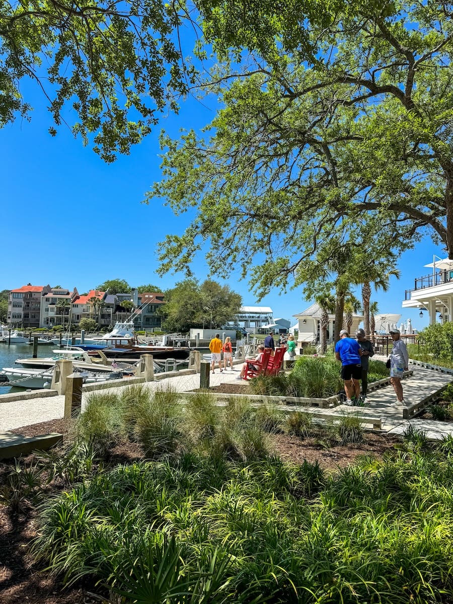 Image of the harbor along with rocking chairs and large boats