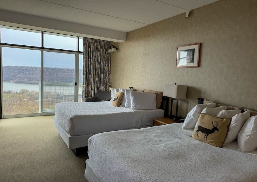 Image of Riverview Room at the Clifty Inn featuring two queen beds and a large window with views of the Ohio River. 