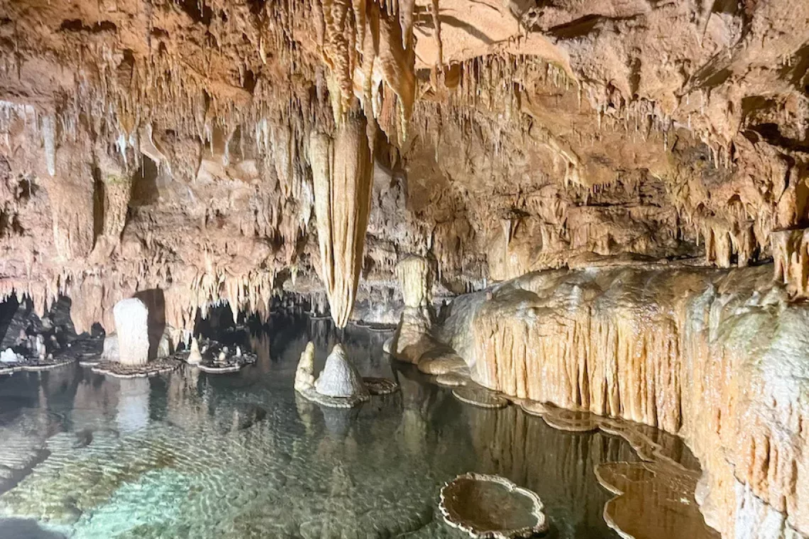 Caves in Missouri - View of Lily Pad Room at Onondaga Cave State Park. Inside of cave filled with clear, blue water.