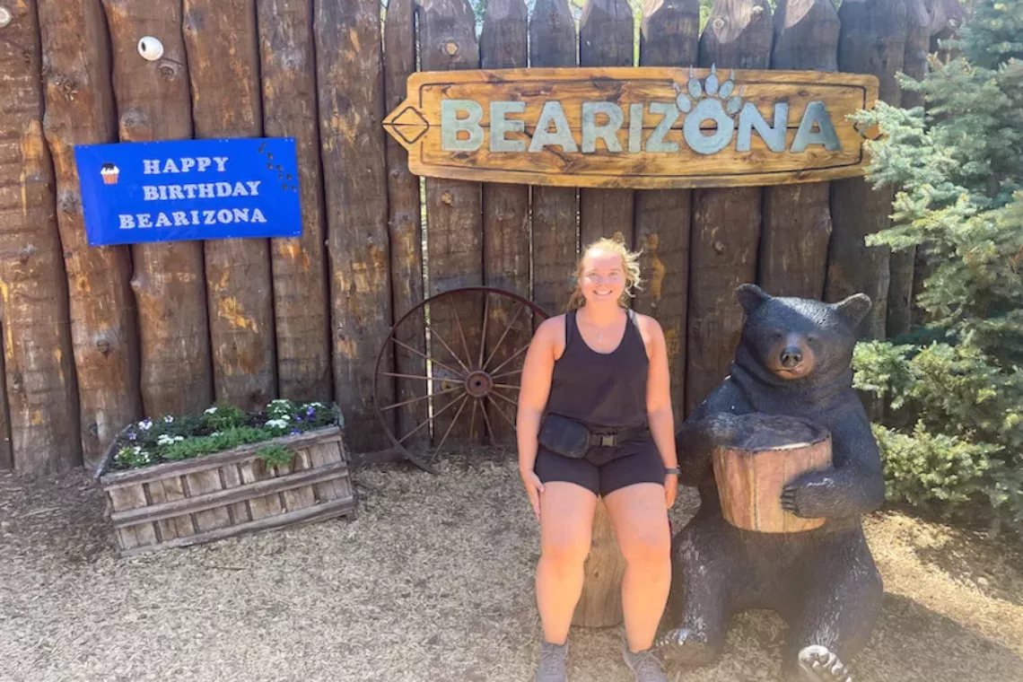 Woman posing in front of Bearizona Wildlife Park sign in Arizona