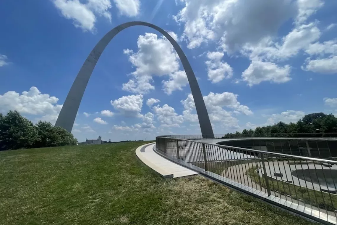 Image of Gateway Arch at Gateway Arch National Park in St. Louis, Missouri. Bright blue and cloudy sky.