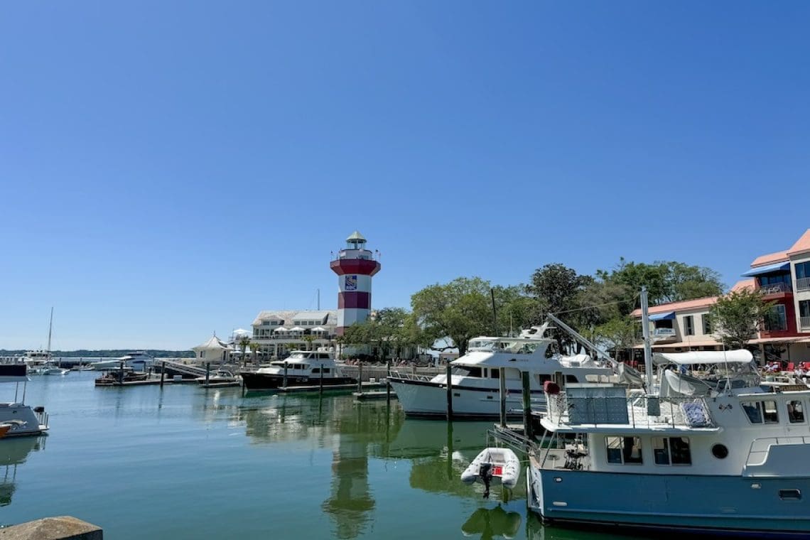 Image of Harbour Town and the Harbour Town Lighthouse surrounded by blue sky and water - Guide to Hilton Head Island