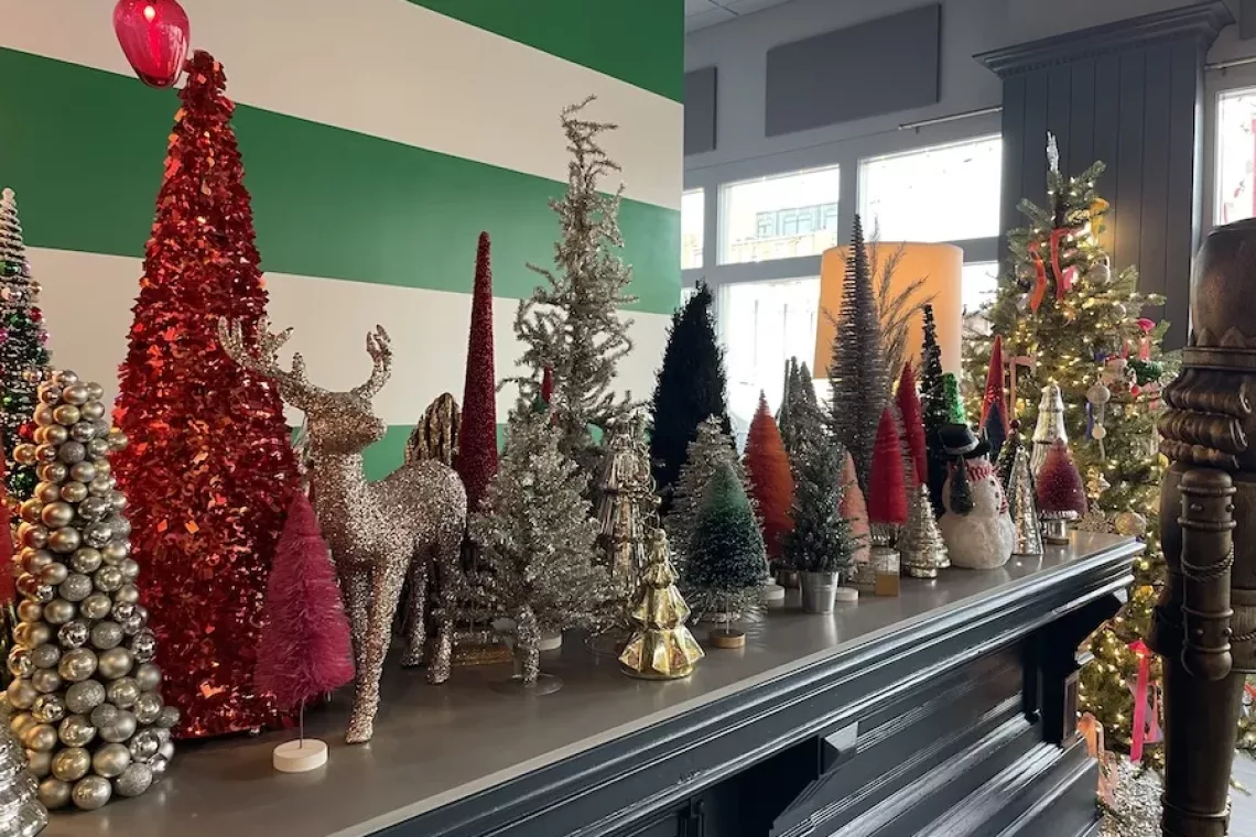 Mini Christmas Trees decorating a mantle - Holiday Events in Downtown Davenport