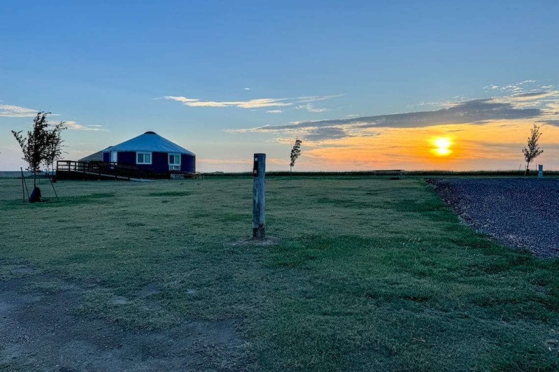 Image of cabin and sunset surrounded by grass in Southern Kansas