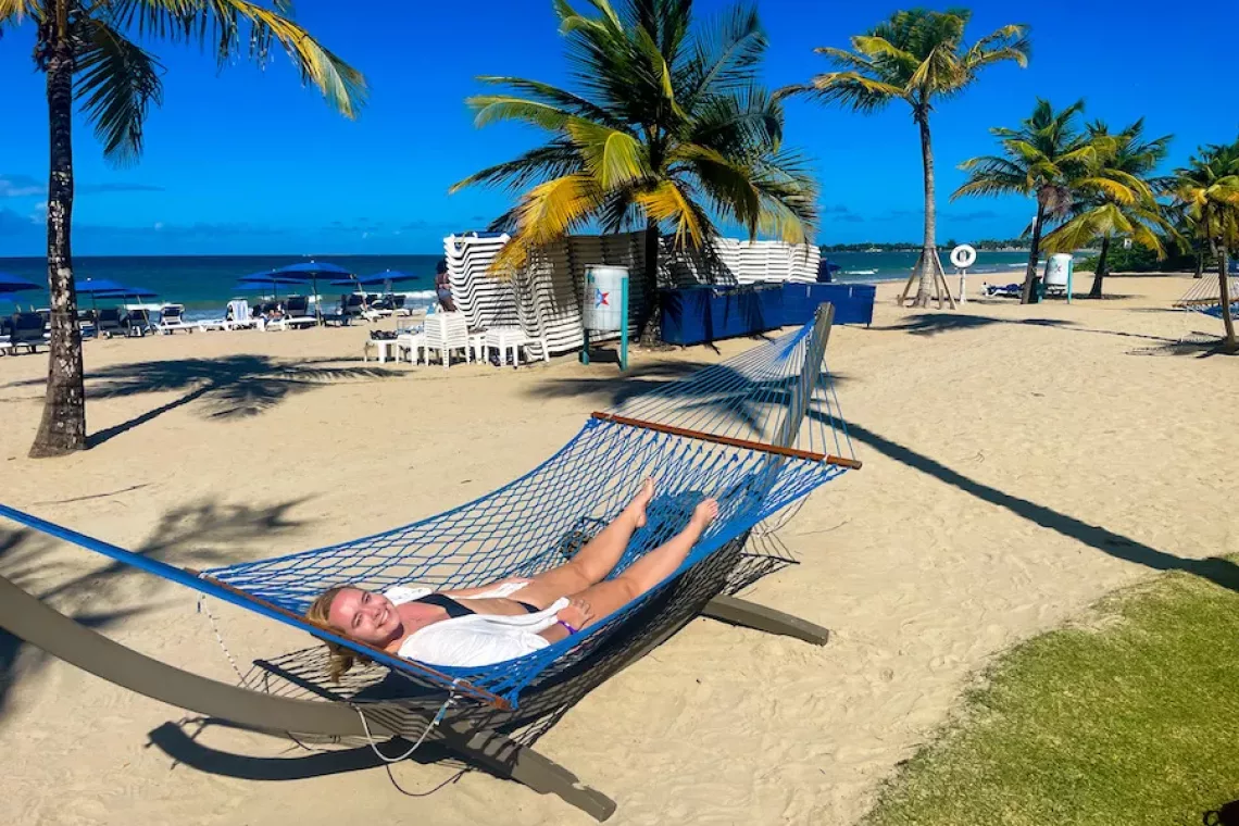 Woman in hammock on beach at Courtyard Isla Verde Beach Resort