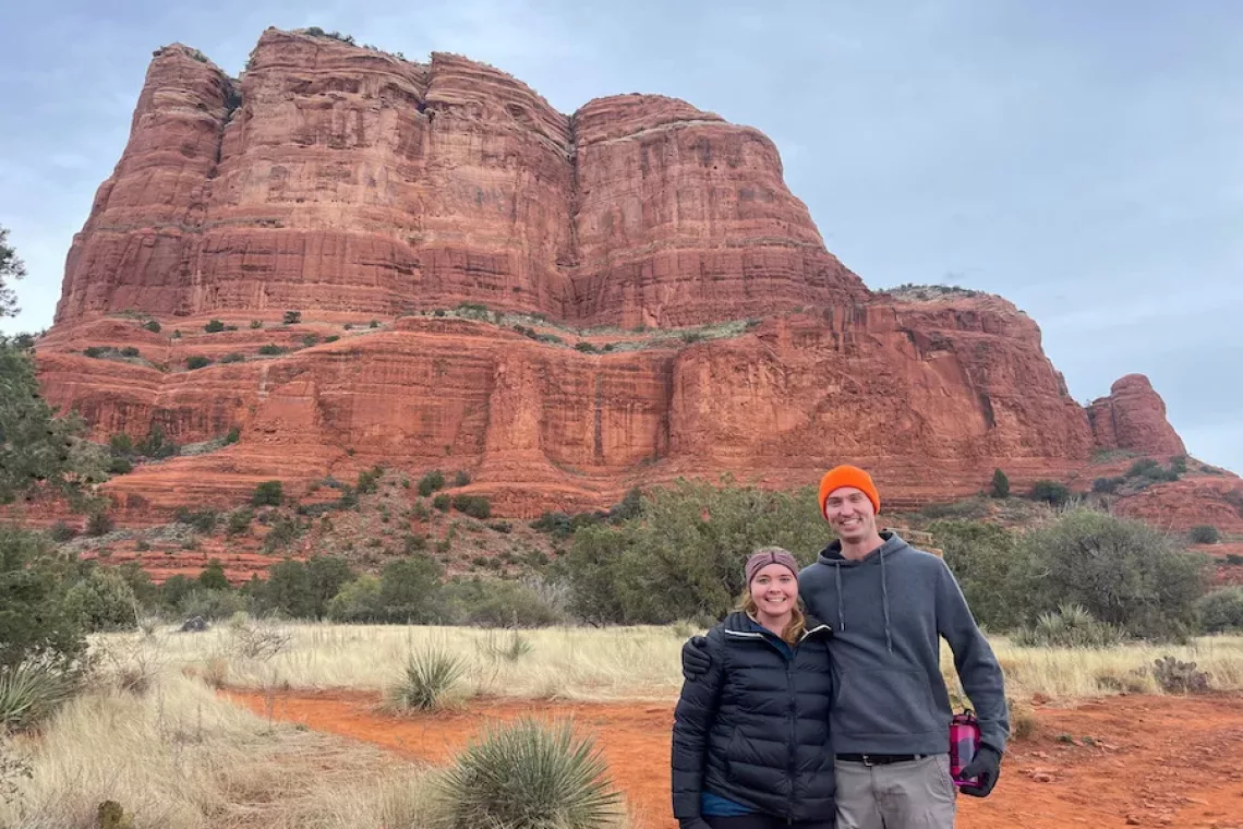 Passion for Travel - Husband and Wife posing in front of rock formation in Sedona, AZ