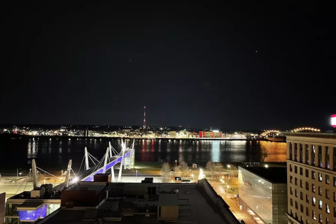 View of the Davenport Riverfront at night from Sky Bar - Food and Drink in Downtown Davenport